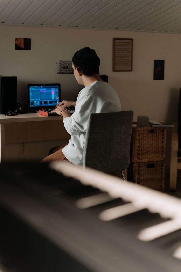 Man Sitting On Chair And Working On Computer