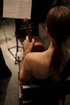 Female violinist skillfully playing in a classical music setting indoors.