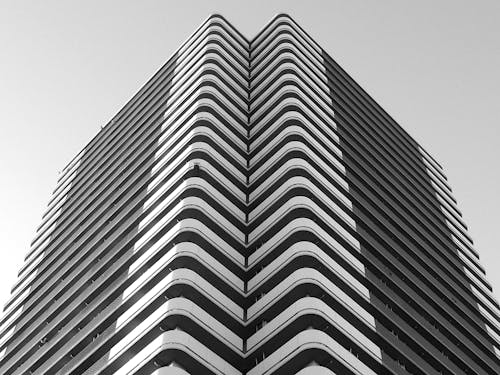 Minimalist geometric building with curvy balconies in city