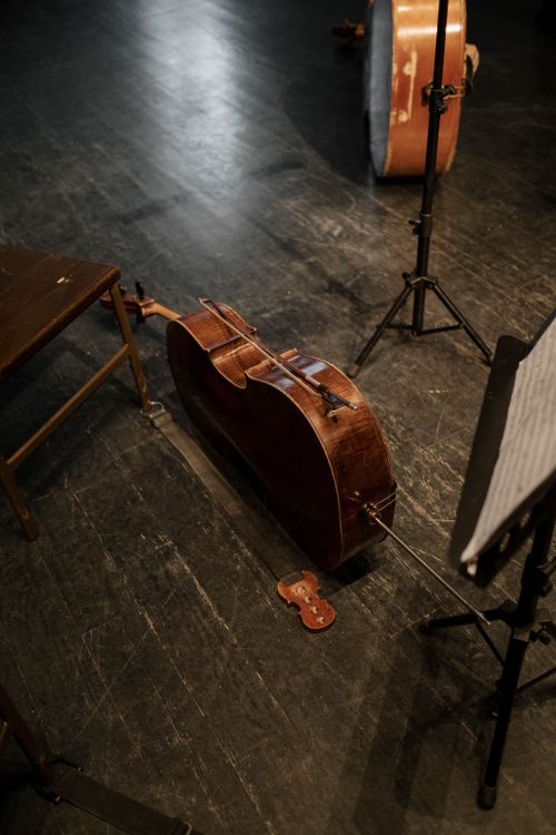Free A cello resting on stage, capturing the essence of classical music performance. Stock Photo