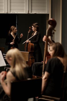 Musicians tuning instruments before a classical music concert performance.