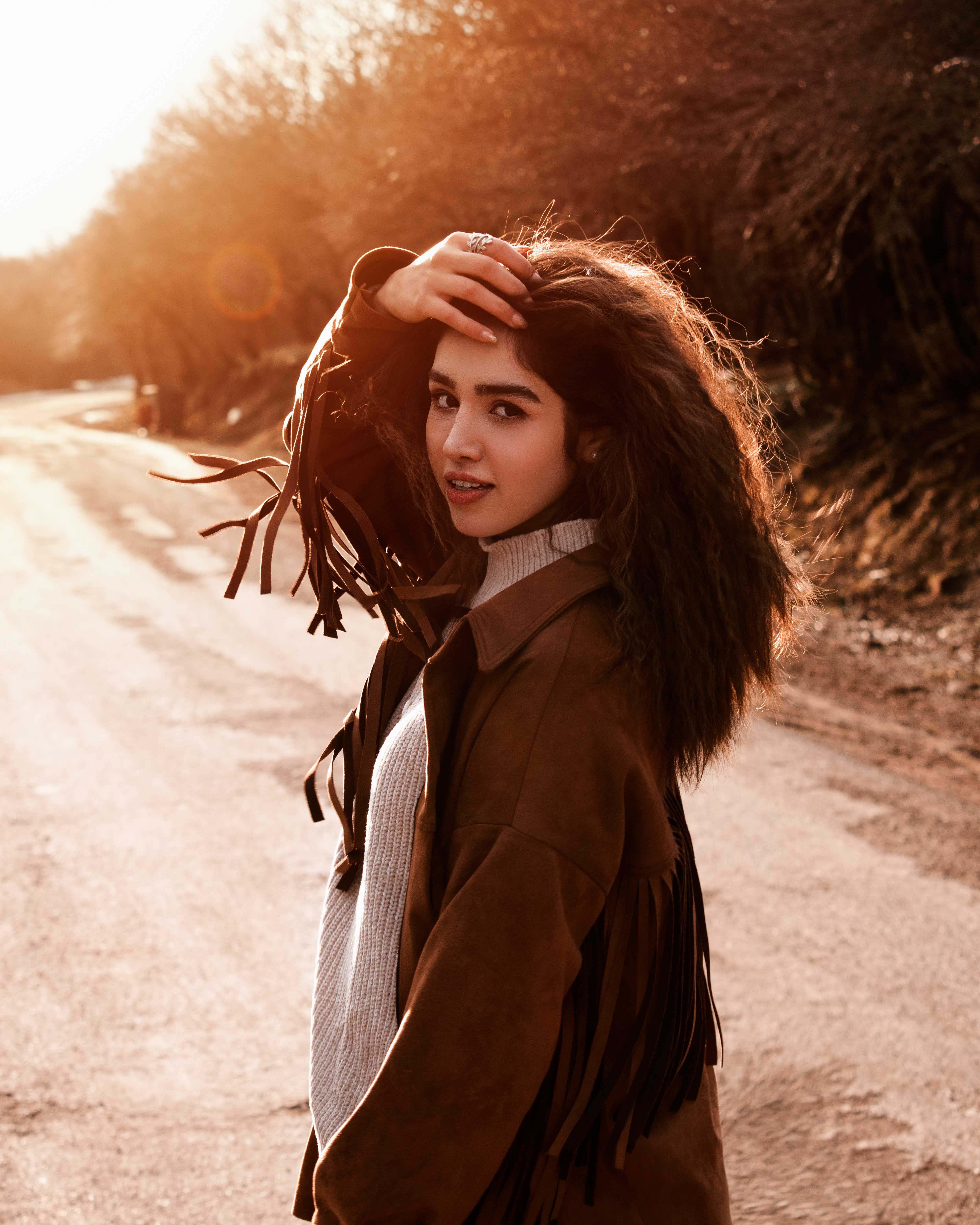 A Woman in Brown Coat Looking at the Camera · Free Stock Photo