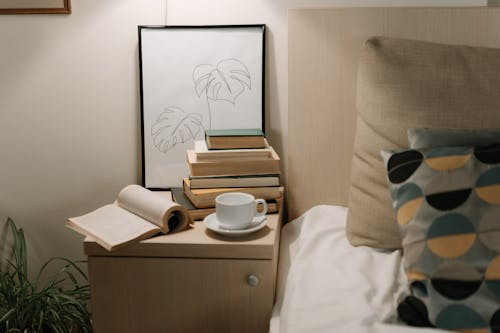 Free Stack of Books on Bedside Table Stock Photo