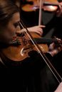 Boy Playing Violin in Black Room