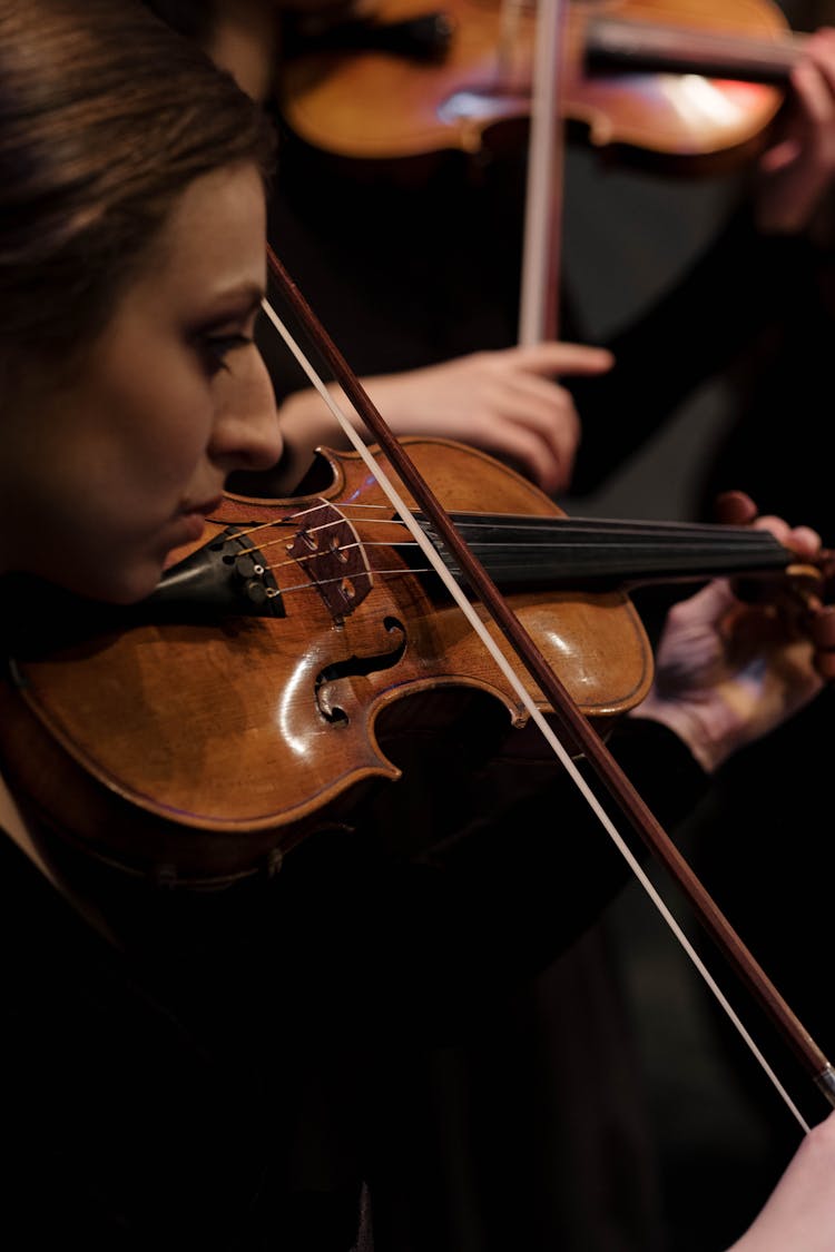 Boy Playing Violin In Black Room