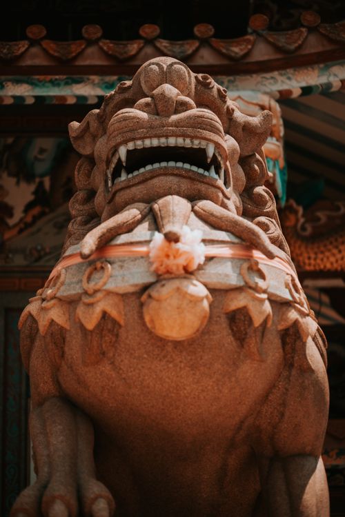 Free A detailed close-up of a traditional stone lion sculpture in Chonburi, Thailand, showcasing intricate craftsmanship. Stock Photo