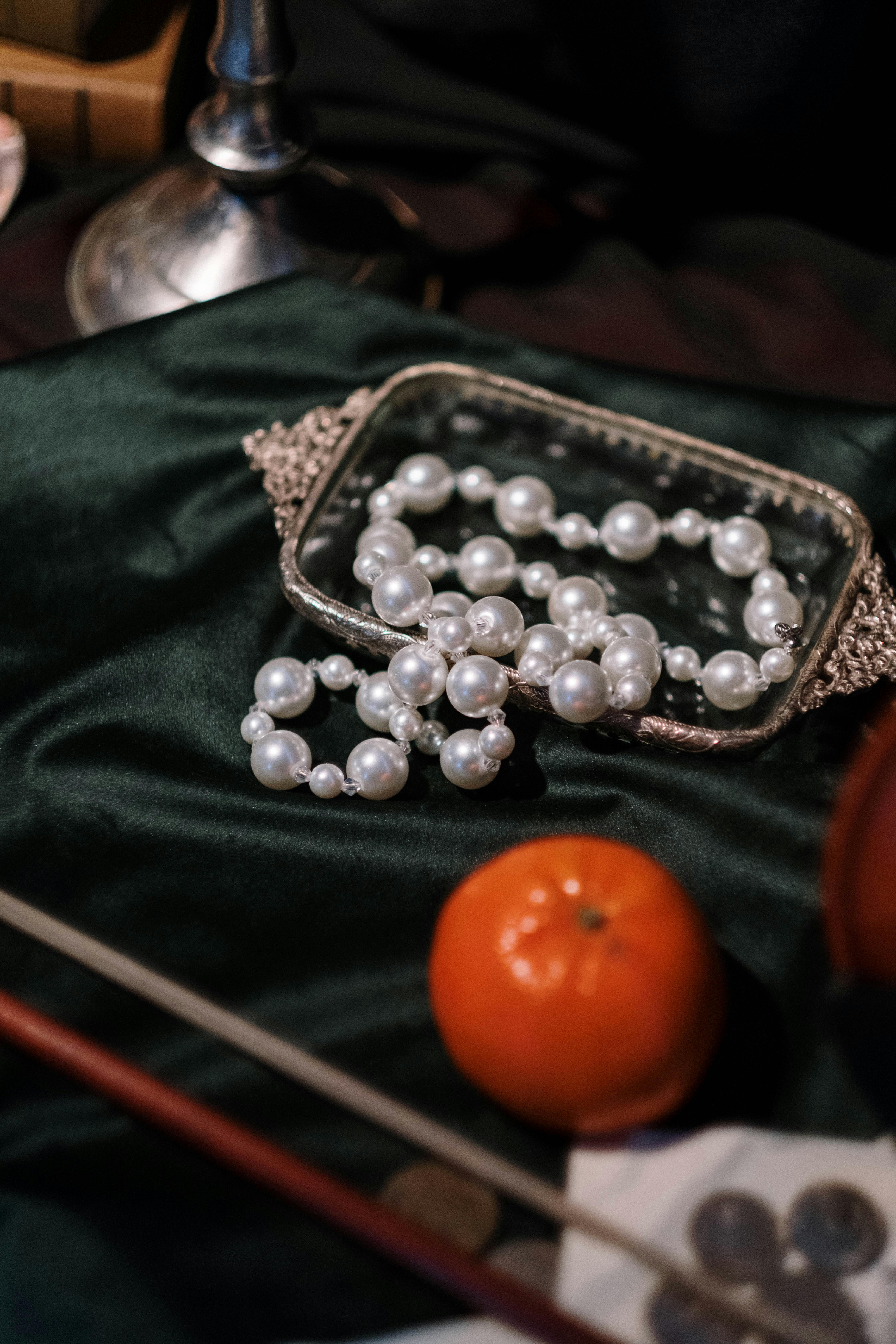 pearl necklace on glass lid