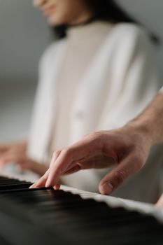 Artistic close-up of a person playing piano with a soft focus background, capturing the essence of music and expression.