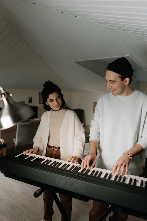 Man and Woman Playing Keyboard