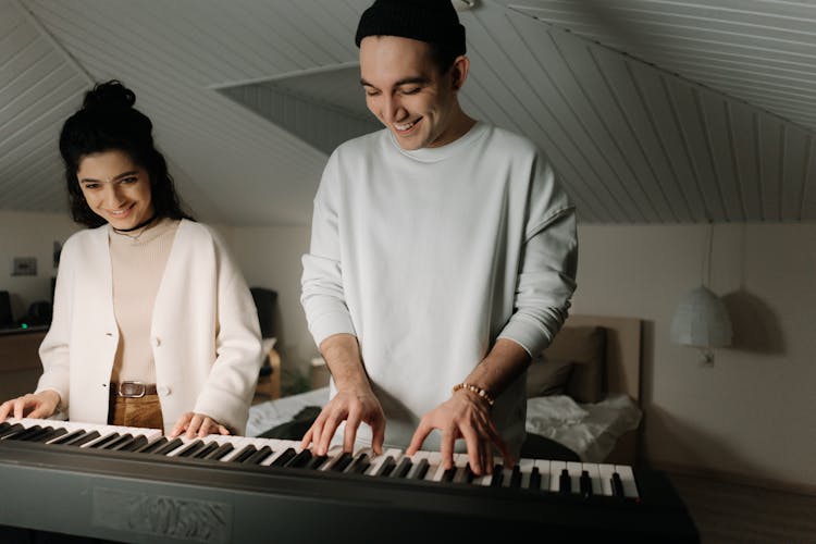 A Couple Playing The Keyboard