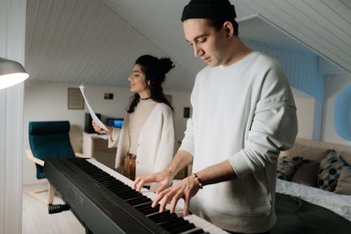 Free A Man Playing the Piano with Woman Singing Stock Photo