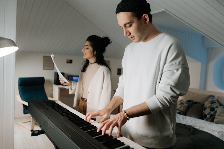 A Man Playing The Piano With Woman Singing