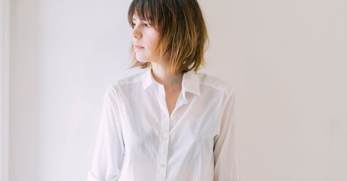Woman in White Dress Shirt and Blue Jeans