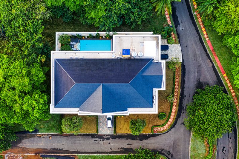 Aerial drone view of luxury villa with pool