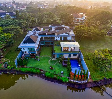 Stunning aerial view of a luxury villa by the river in Tangerang, Indonesia.