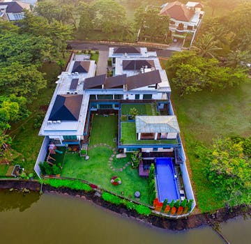 A stunning aerial view of a luxury riverside mansion in Tangerang, Indonesia.