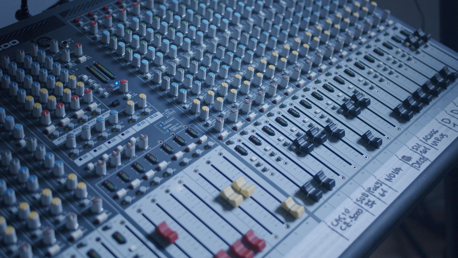 Mixing console faders in the control room