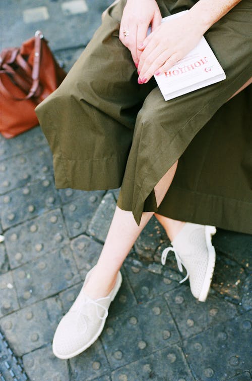 Person Wearing Green Skirt and Pair of White Low Top Sneakers