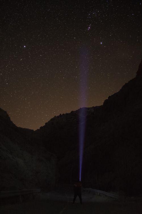 Free A dramatic silhouette under a starry sky in Iran, casting a beam of light into the night. Stock Photo
