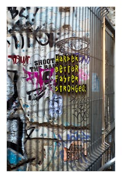 Vibrant graffiti art on a corrugated metal wall, showcasing street art expressions.