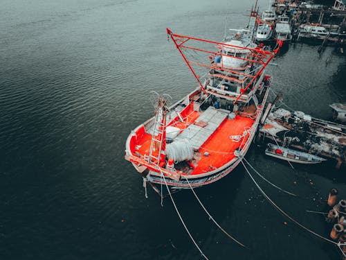 Fishing ship moored in dock with boats