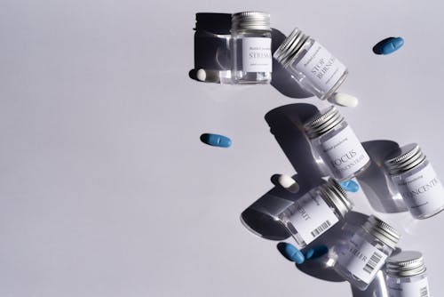 Free Close-Up Shot of Medicines on a White Surface Stock Photo