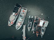 Fishing vessels with fishing equipment in sea