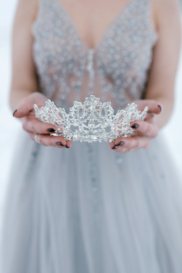 A Woman Holding A Tiara