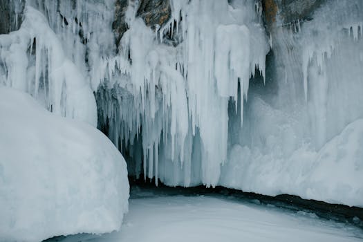Captivating frozen icicles hang from a cave wall, epitomizing the heart of winter.