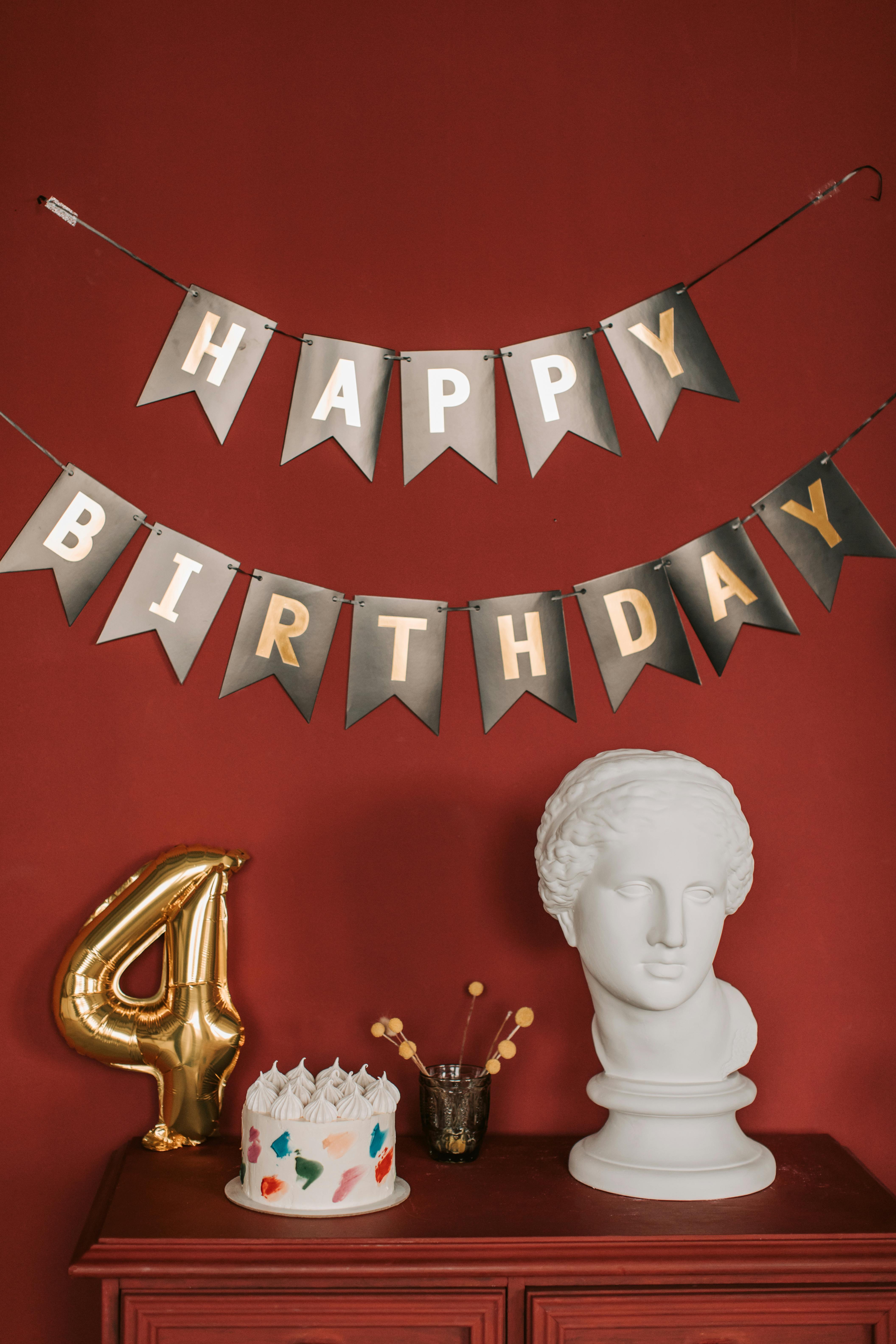 a birthday cake and a head bust