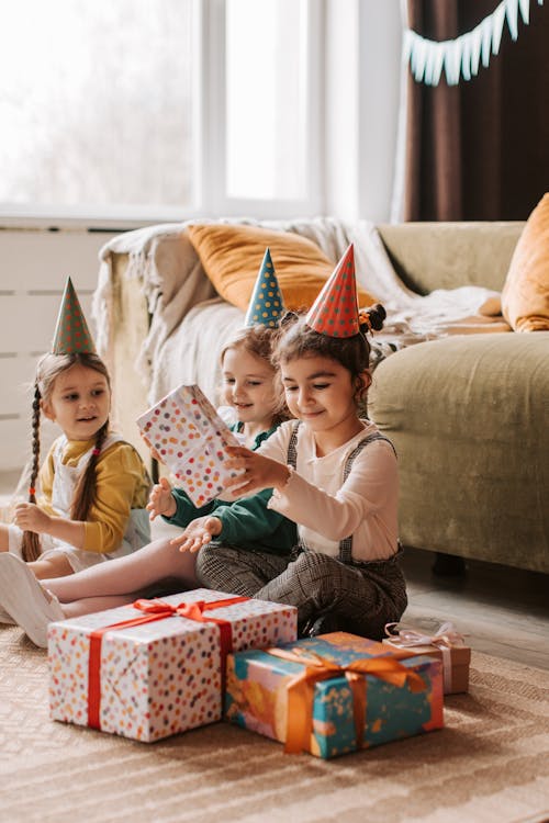 Free A Kid Opening a Present at a Party Stock Photo