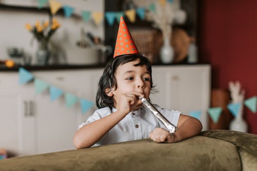 A Kid Blowing a Party Horn 