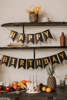 A cozy indoor birthday setup with cake, decorations, and fresh fruit.