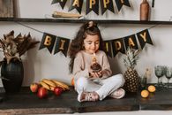 Little Girl Sitting on Wooden Table