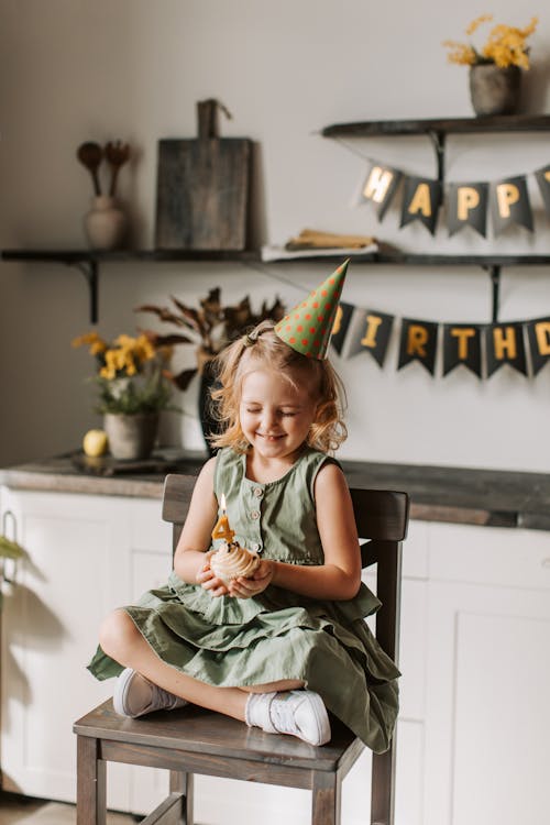 Happy Little Girl in Dress at Birthday Party