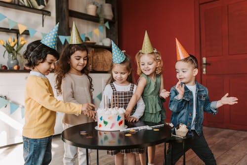 Children Standing beside Black Table