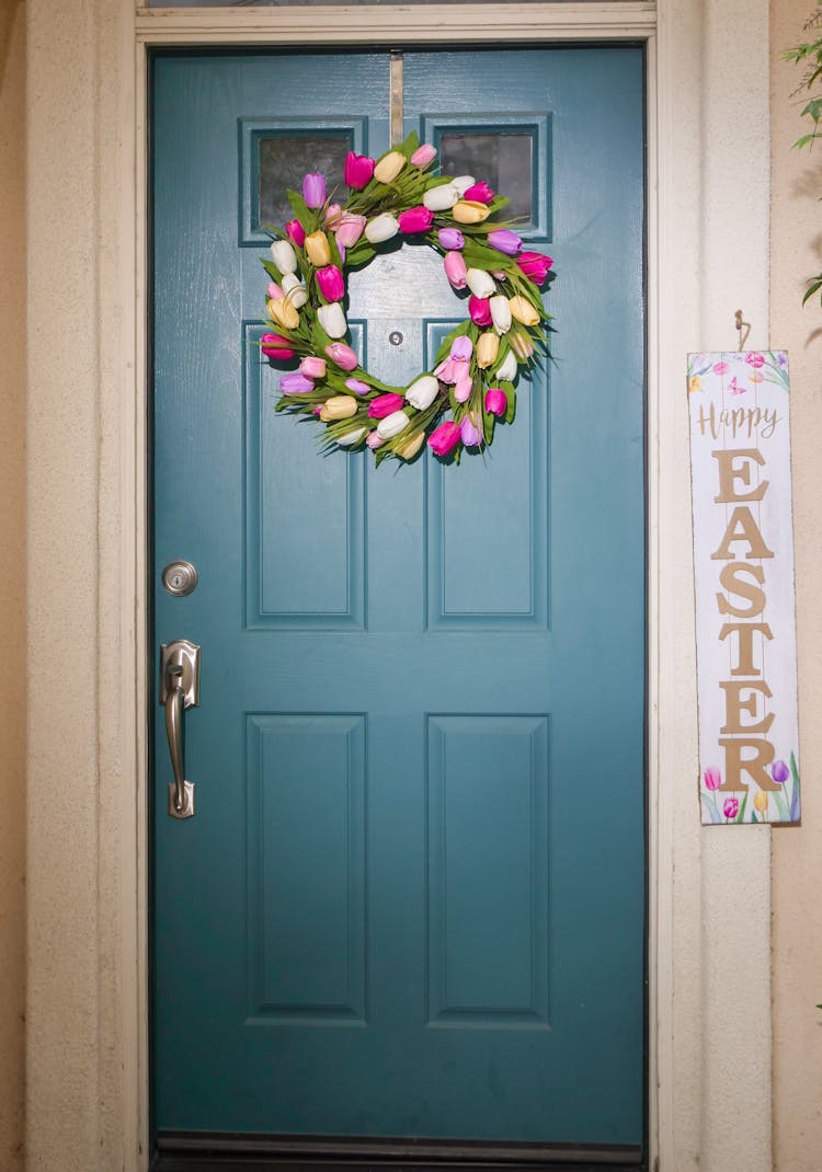 A Floral Wreath Hanging On A Wooden Door