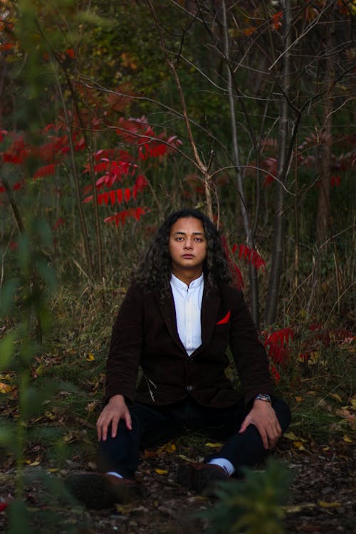 Free A Curly Haired Sitting on Grass Stock Photo