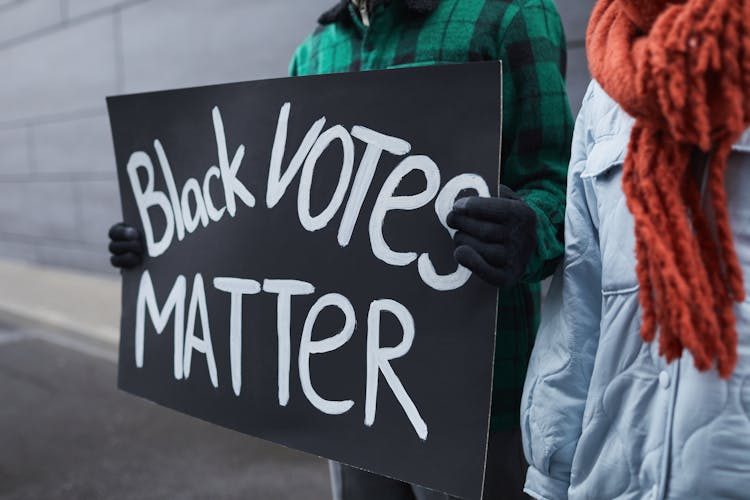  A Person Holding A Political Poster