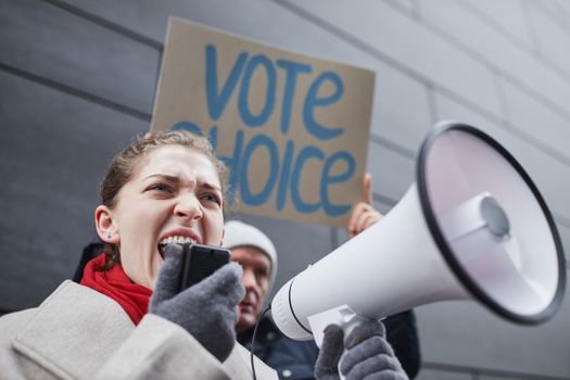 A Woman Speaking on a Megaphone