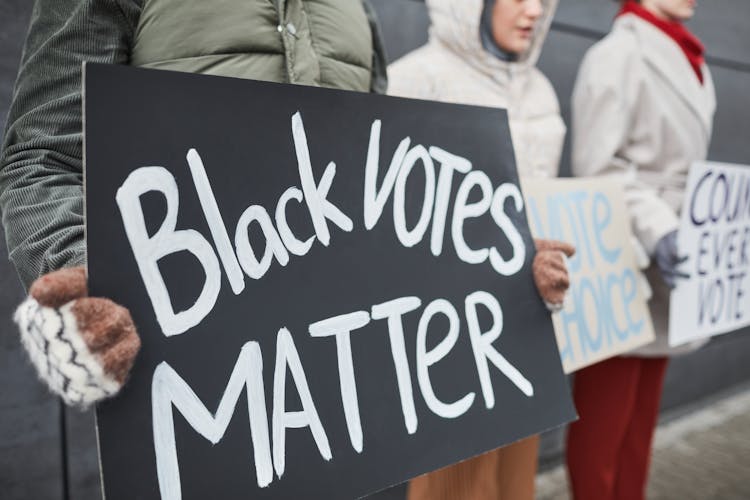 A Person Holding Black Votes Matter Placard