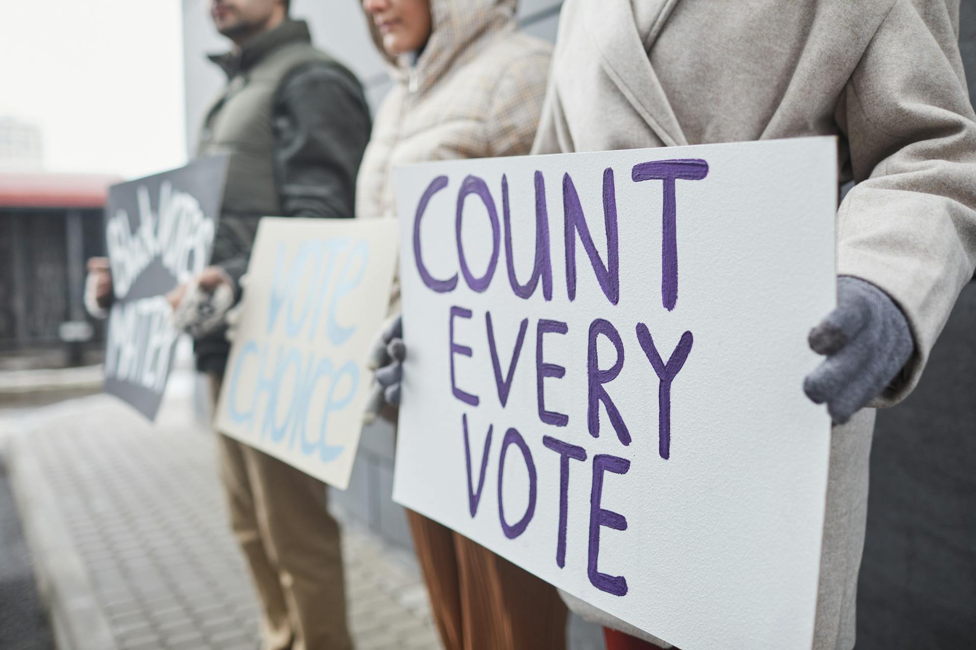 People Holding Protest Posters in a Rally