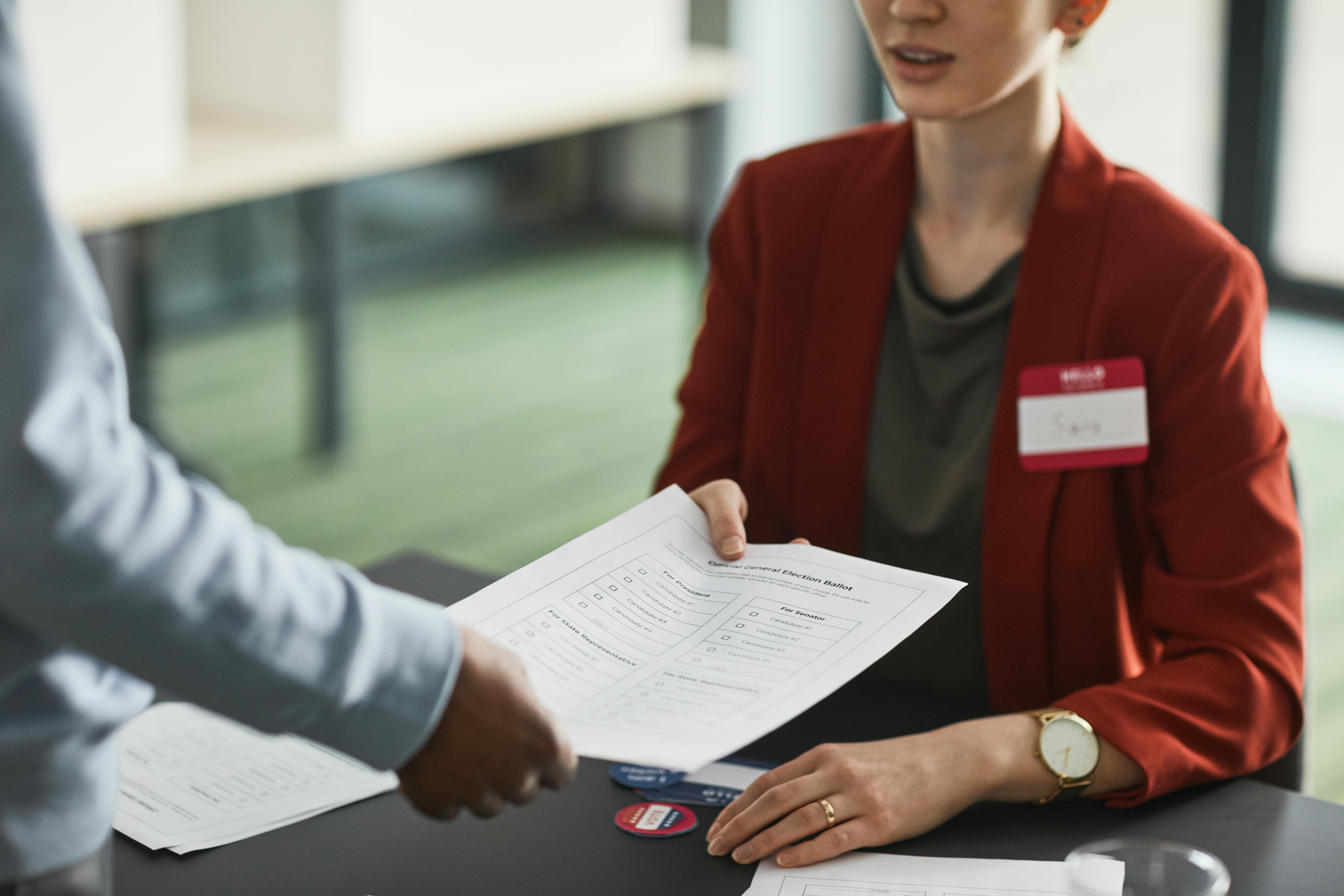 A Woman in Red Blazer Holding a White Paper