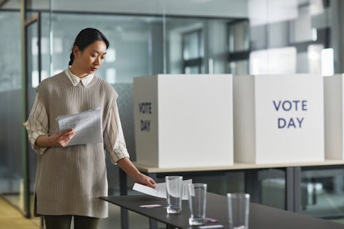 Man in White Button Up Shirt Standing Near Table