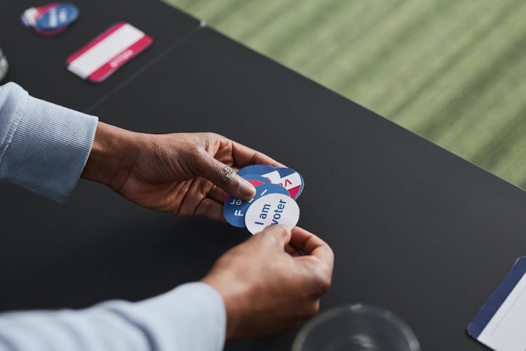 A Person Holding A Voter Sticker