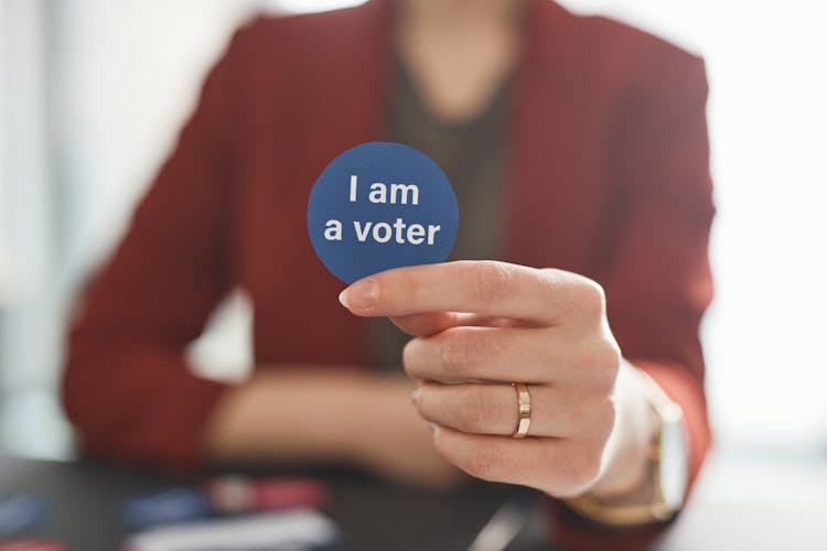 A Person Holding A I Am A Voter 