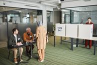 A Man in Brown Sweater Talking to Hijab Woman