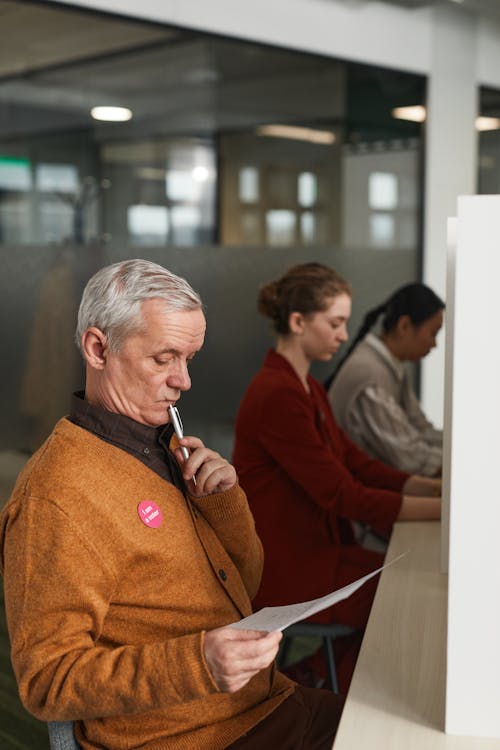 A  Male Voter Reviewing His Ballot