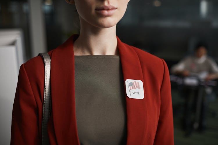 Woman In Red Blazer And Badge