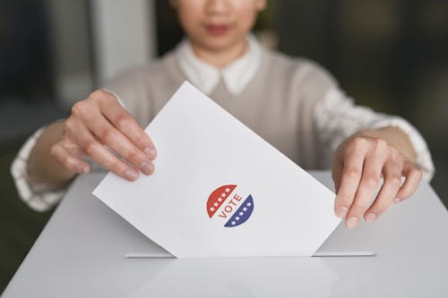 Person Putting a Ballot in the Box
